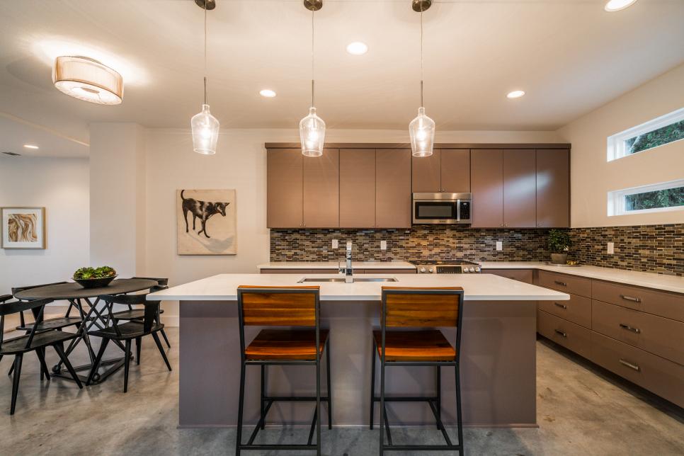 Modern kitchen interior with pendant lighting and bar stools.
